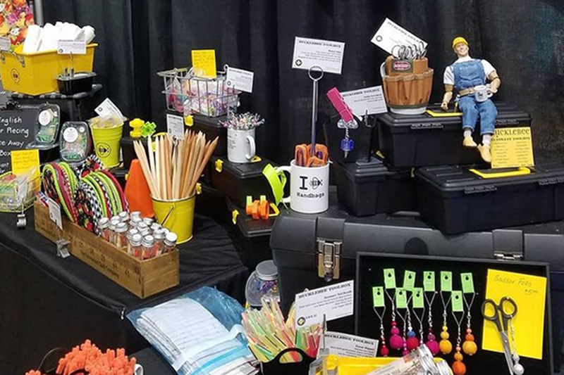 Joan's booths at events include display items like construction worker figurines and tools boxes.