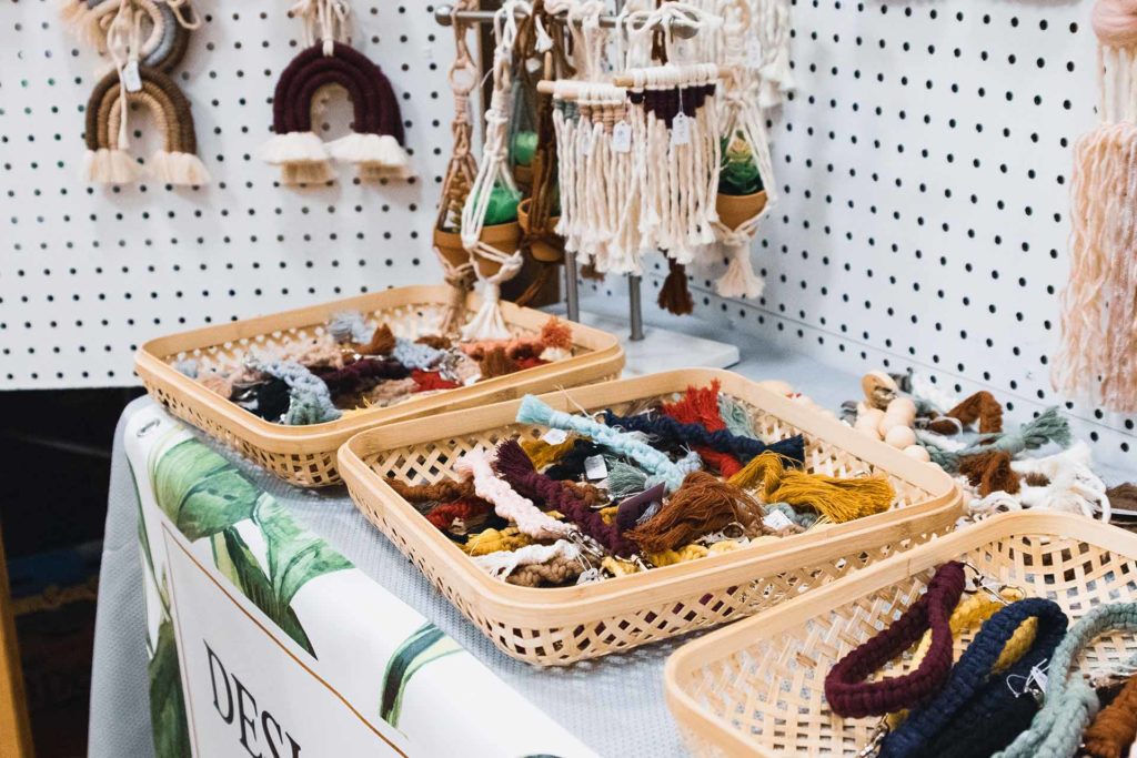 crafts on a booth table for sale at a show.