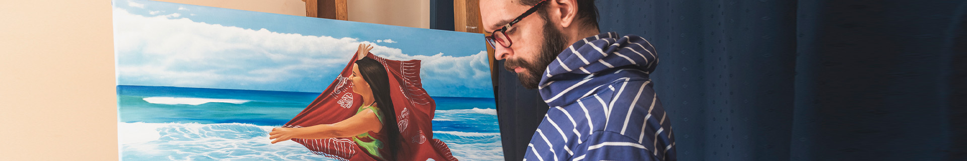A painter works on a traditional oil paint of a hispanic mother on the beach.