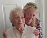 Karen Martin and her mother pose for a photo together inside a home.