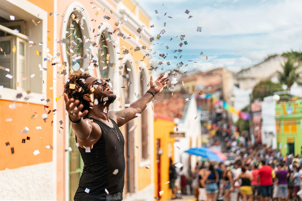 Confetti being thrown in the air by a celebrator at an event.