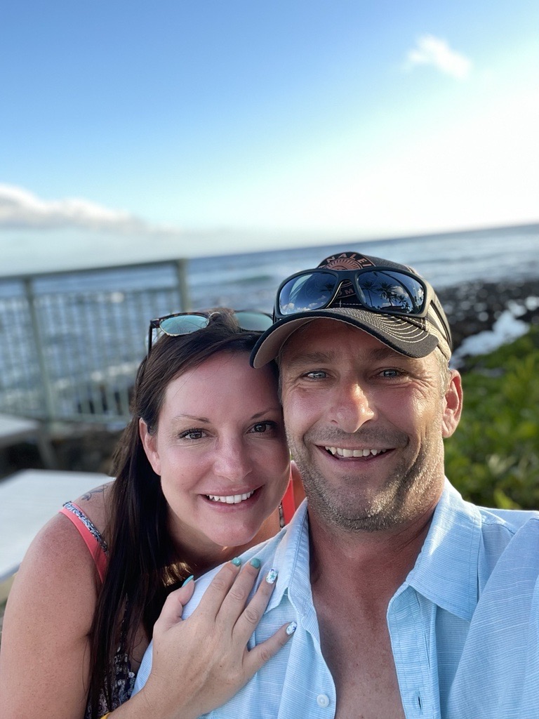 JoAnne poses for a photo with her fiance as they relax near the beach.