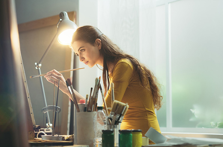 An artist works, insured by ACT insurance.
