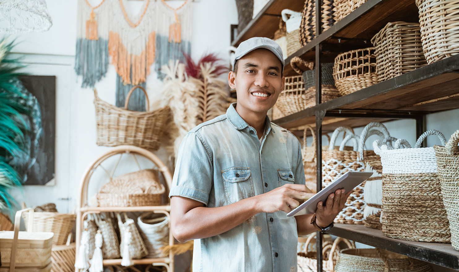 A young vendor is standing next to his display shelves as he access his Certificate of Product Liability Insurance before his event.