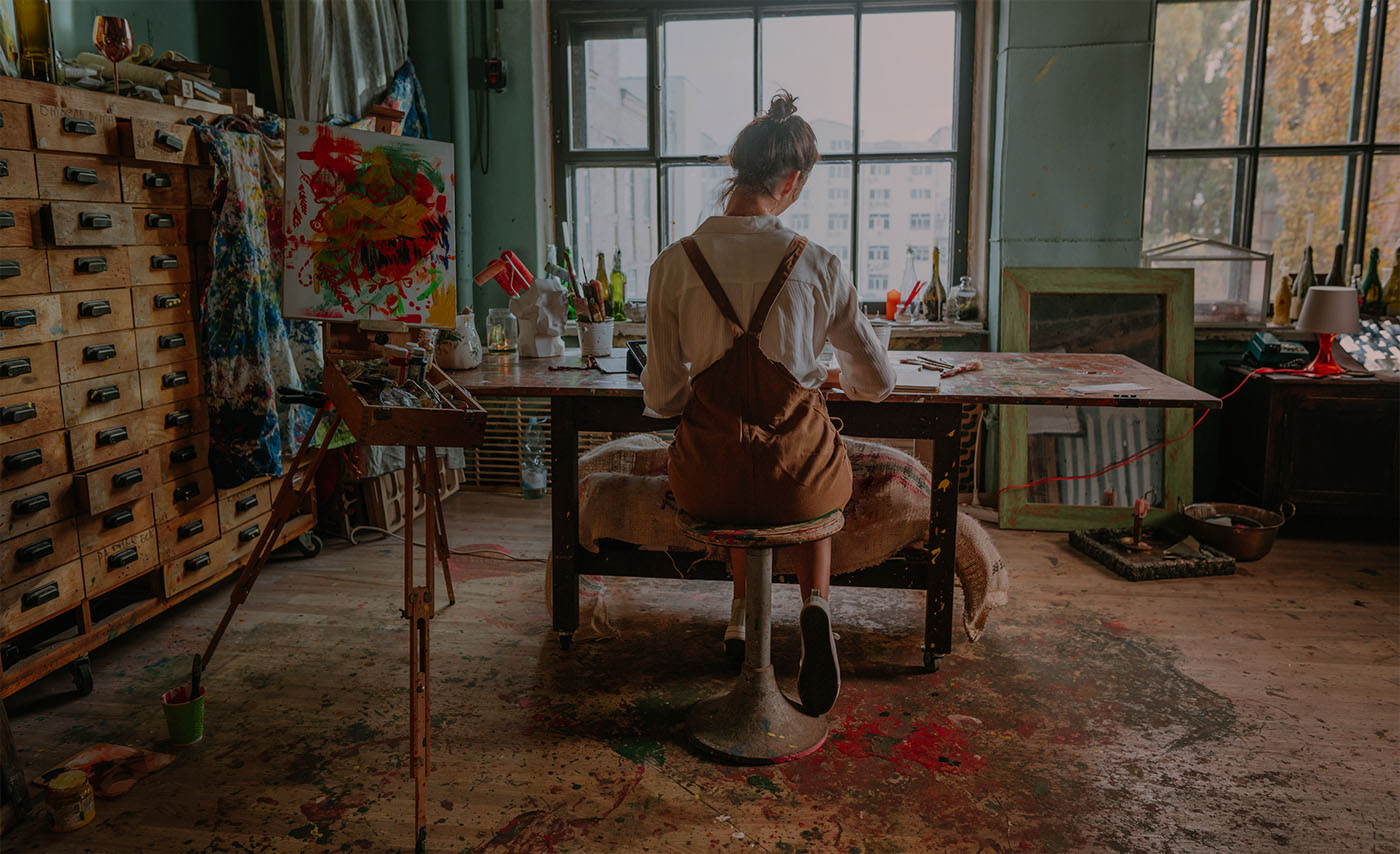 An artists works alone in an art studio.