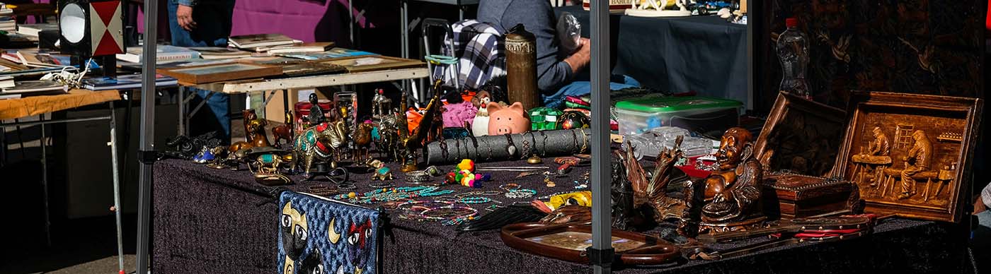 A flea market booth with handcrafted wares.