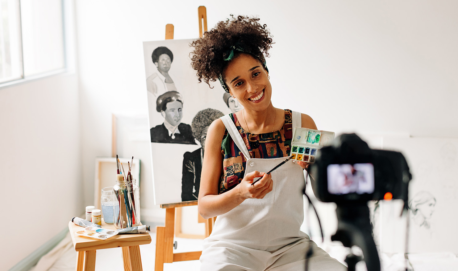 An artist is filming herself in her studio as she makes a video for her social media channels.