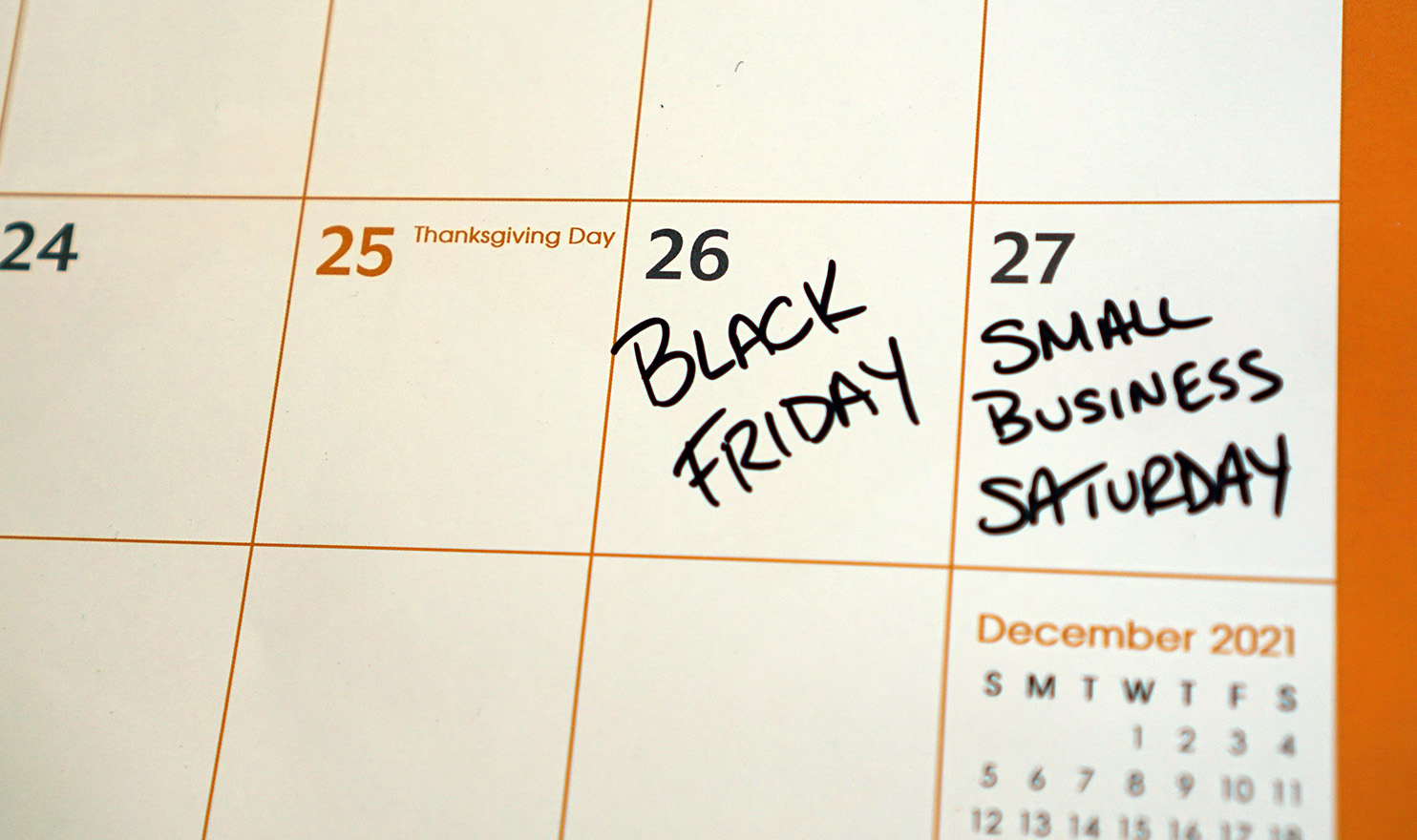 A calendar with the words "Black Friday" and "Small Business Saturday" written in on the Friday and Saturday after Thanksgiving.