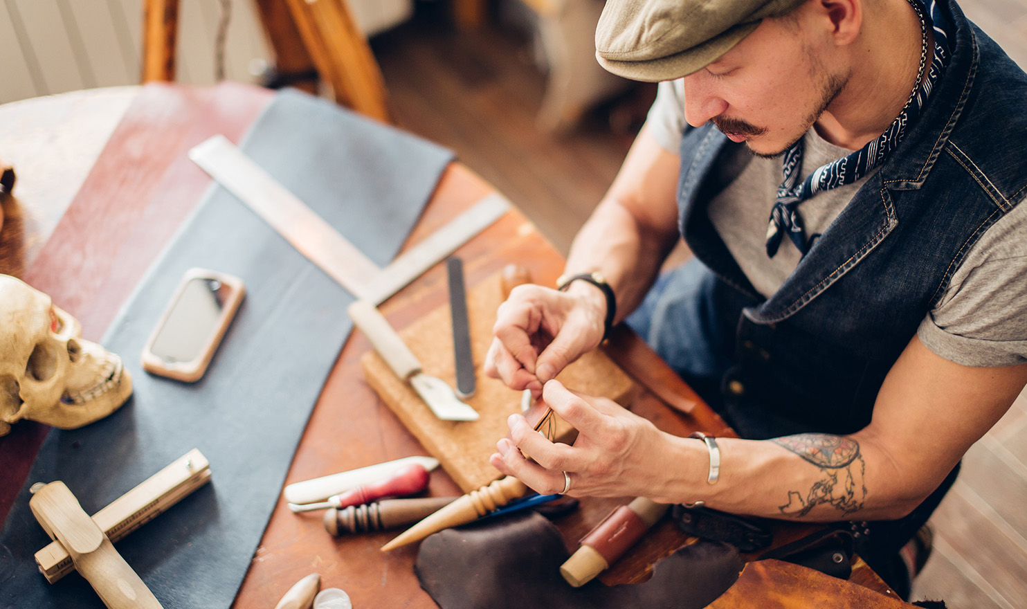 A crafter is working on his piece in his home studio.