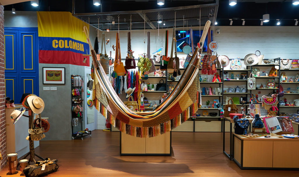 A trade show booth shows a variety of colorful items on display.