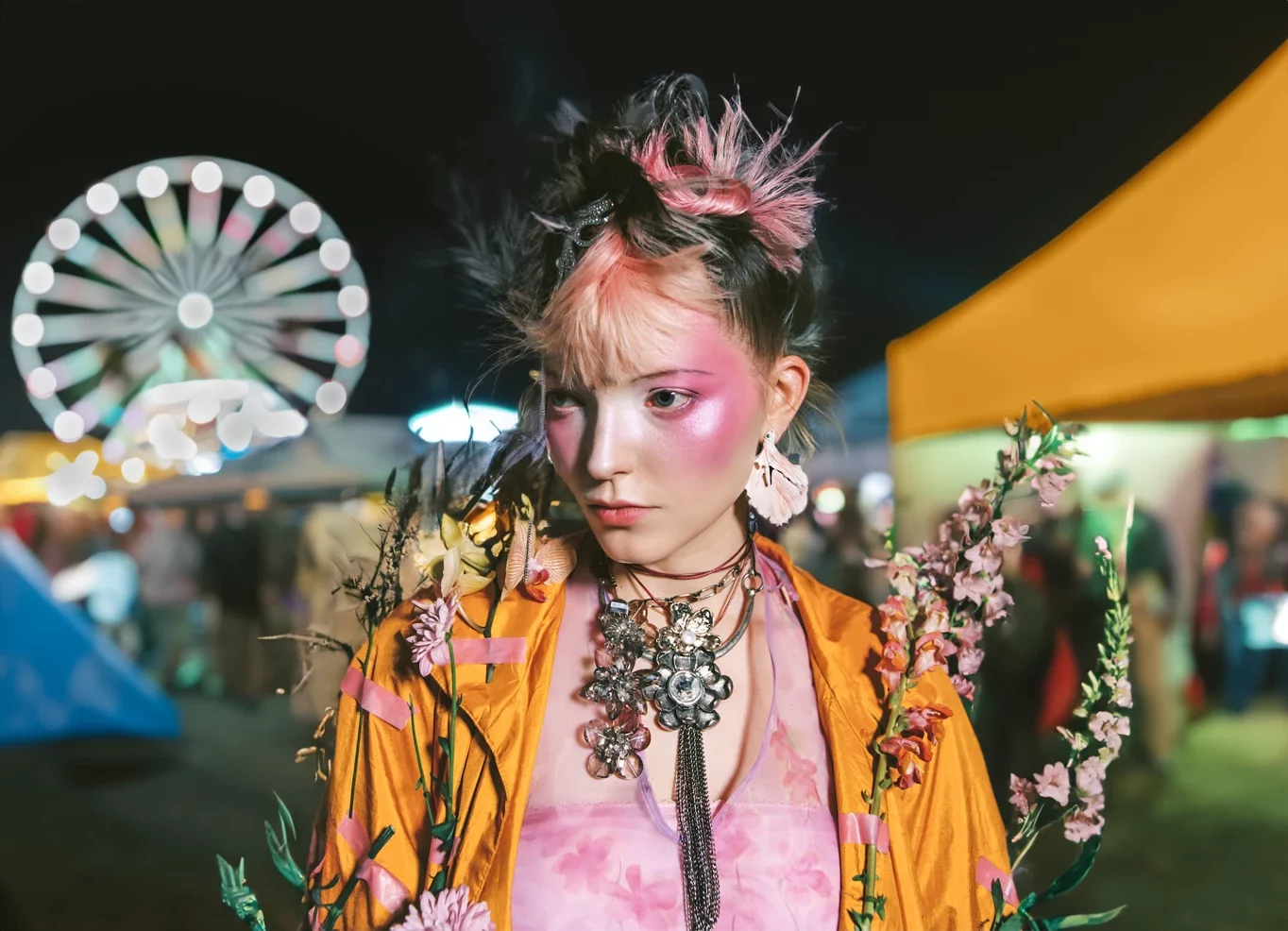 A creator shows their fashion items at a festival.