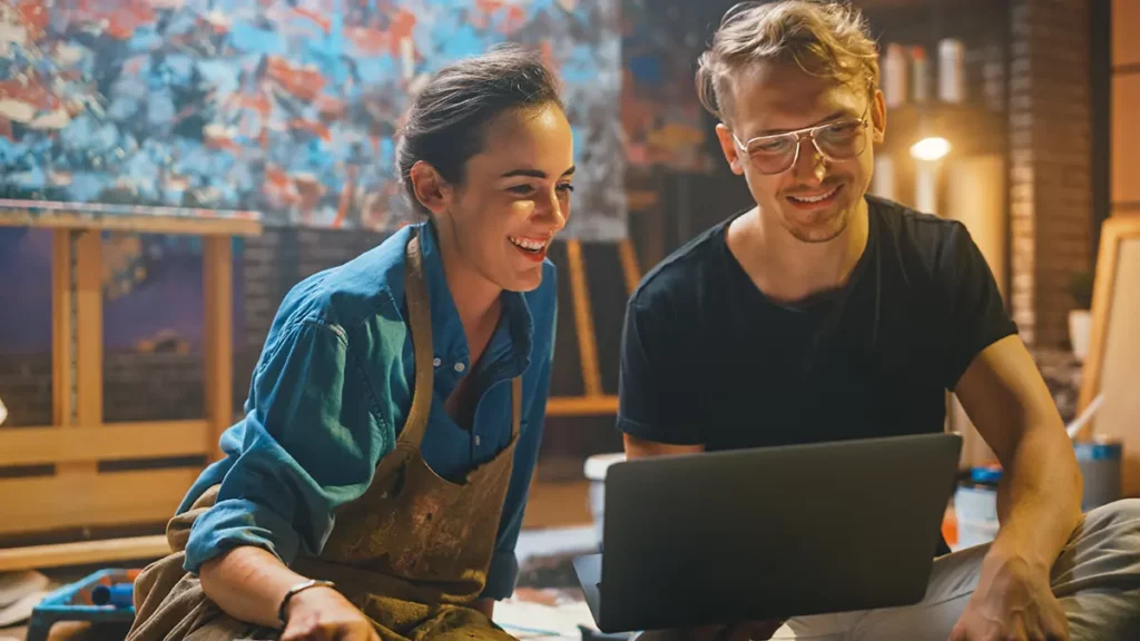 Artists using computer to update their policy information.