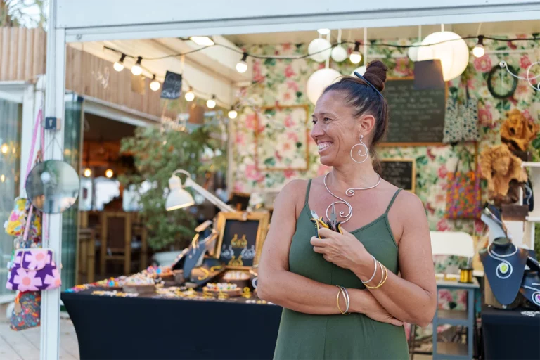 Jewelry vendor at an outdoor market event.